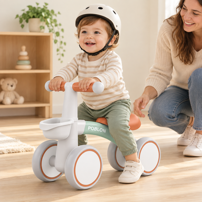 Toddler wearing a helmet riding the Toyella FirstRide balance bike with adult supervision indoors