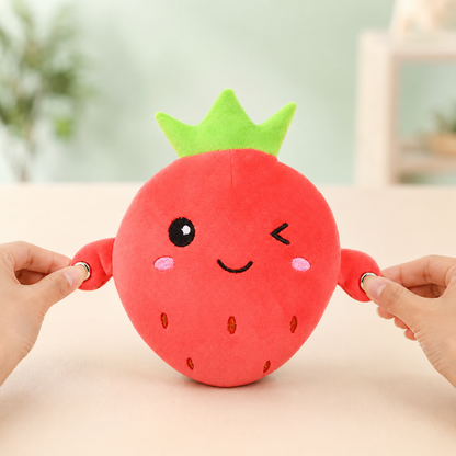 Hands pressing both touch sensors on the strawberry musical plush for solo play
