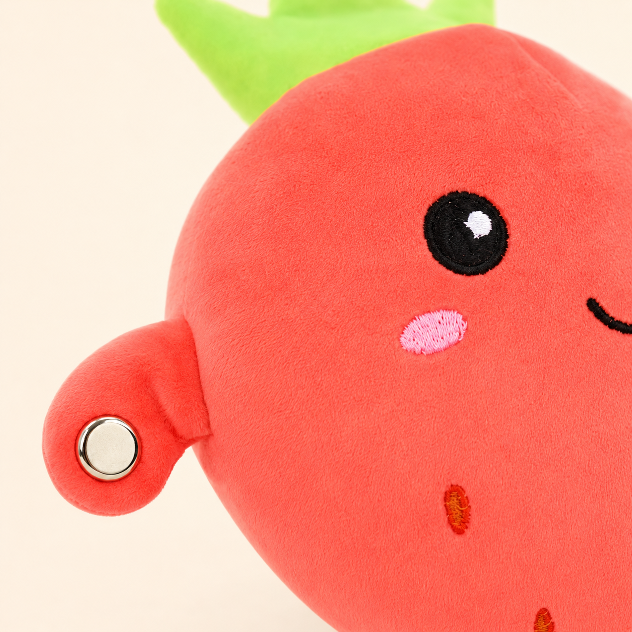 Close-up of the Strawberry Fruit Beat plush and circular touch sensor