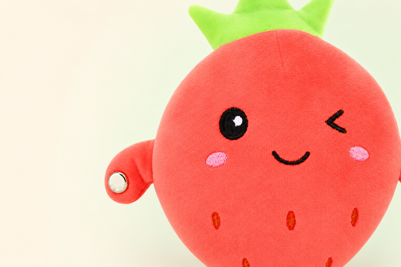 Close-up of the Strawberry Fruit Beat musical plush texture and touch sensor